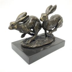 Bronze figure group, modelled as two hares in chase, signed Nick and with foundry mark, upon a rectangular marble base, overall H12cm L16cm