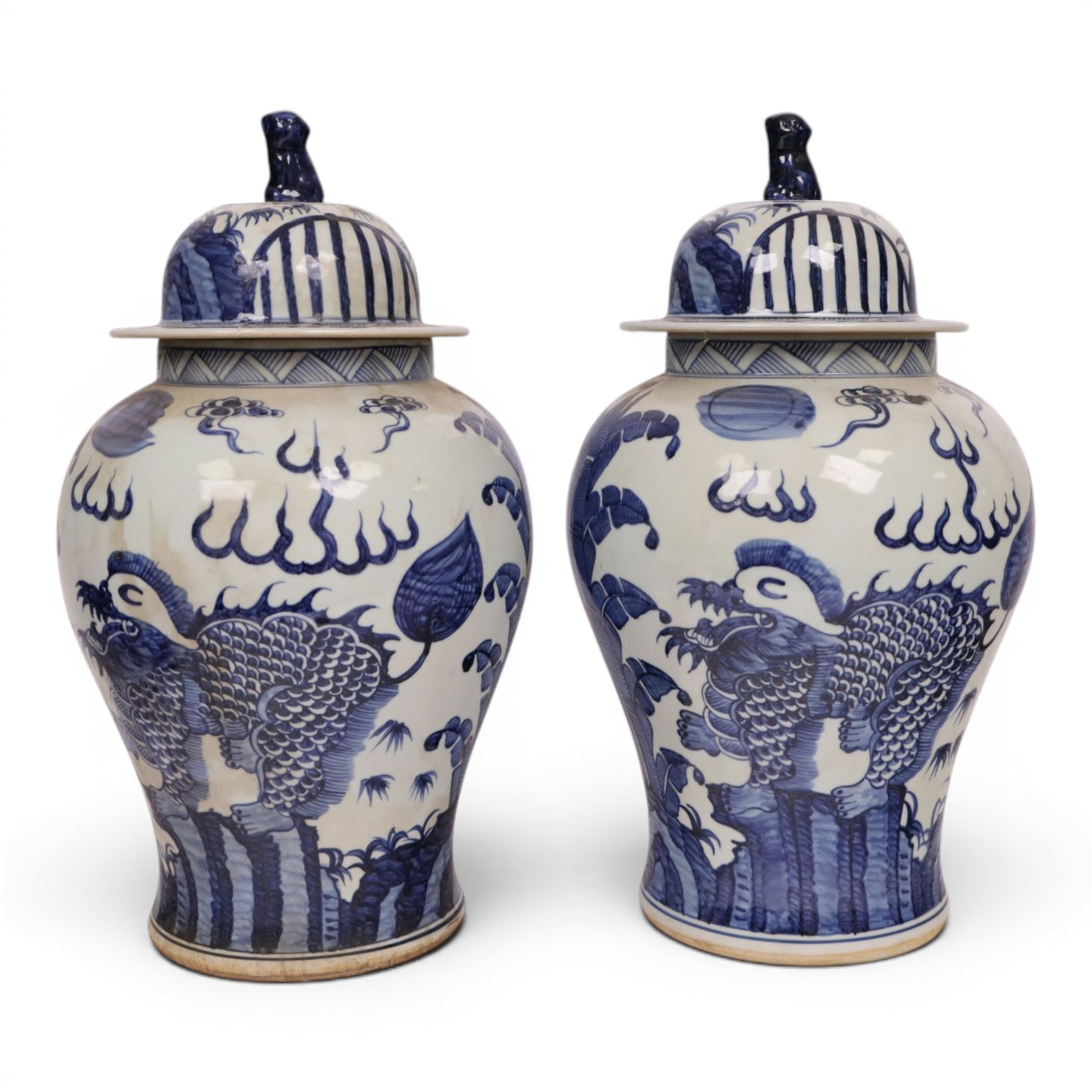 Pair of blue and white Chinese vase and cover, of baluster form, decorated with dragons, the cover with a fo dog finial, H15cm