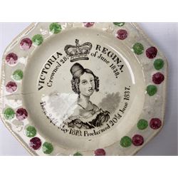 Pearlware Victoria Regina commemorative coronation nursery plate, c1838, of octagonal form decorated with portrait of Queen Victoria surrounded by text reading 'Victoria Regina Crowned 28th of June 1838 Born 24th of May 1819. Proclaimed 20th of June 1837', contained within a floral relief moulded rim heightened in green and pink on plain ground, together with a 19th century Staffordshire style relief moulded jug depicting figures amongst trees bearing fruit, plate D15cm (2)