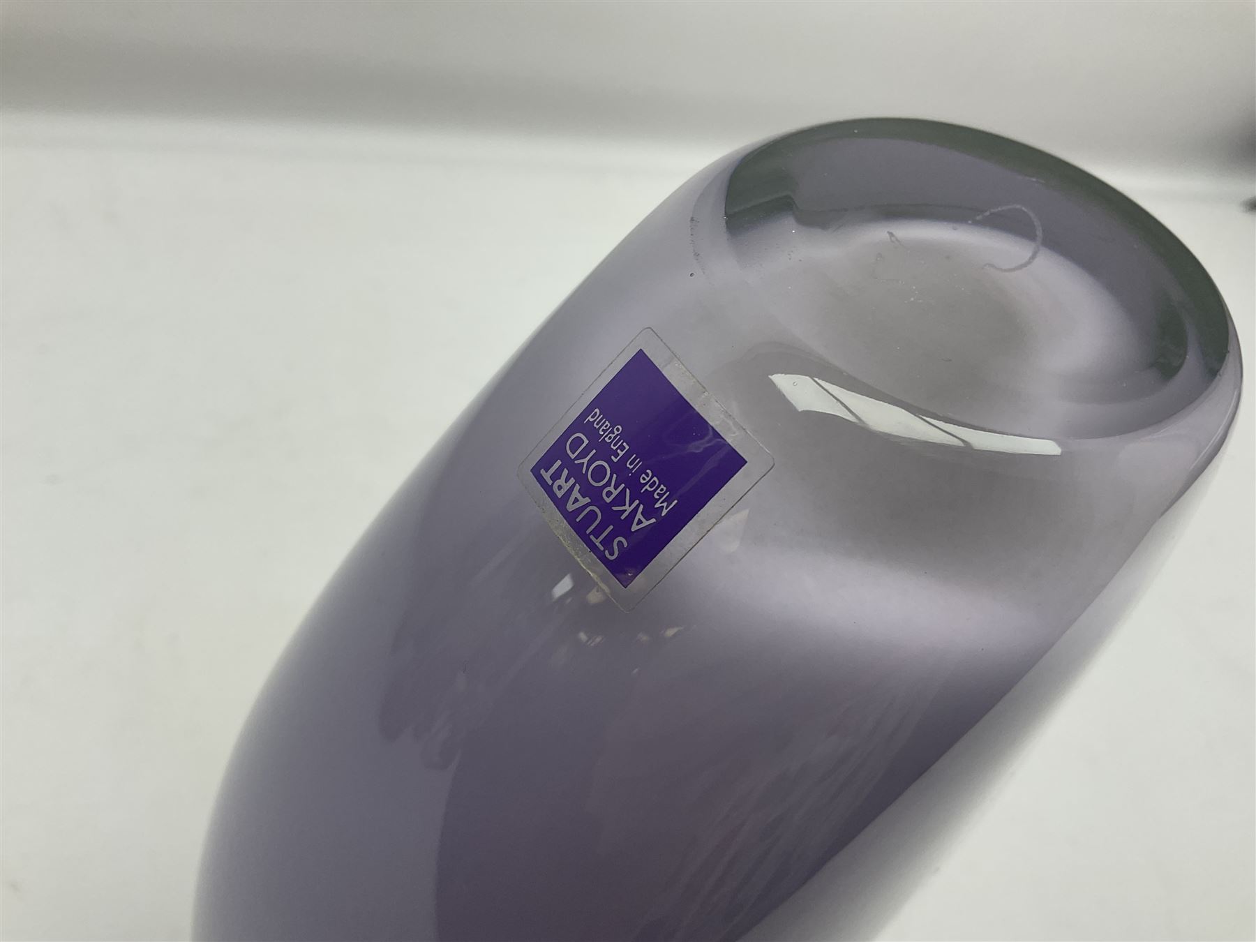 Stuart Akroyd glass vase, green banded top and opaque purple lower section with bubble inclusions, with sticker and engraved signature beneath, H25cm