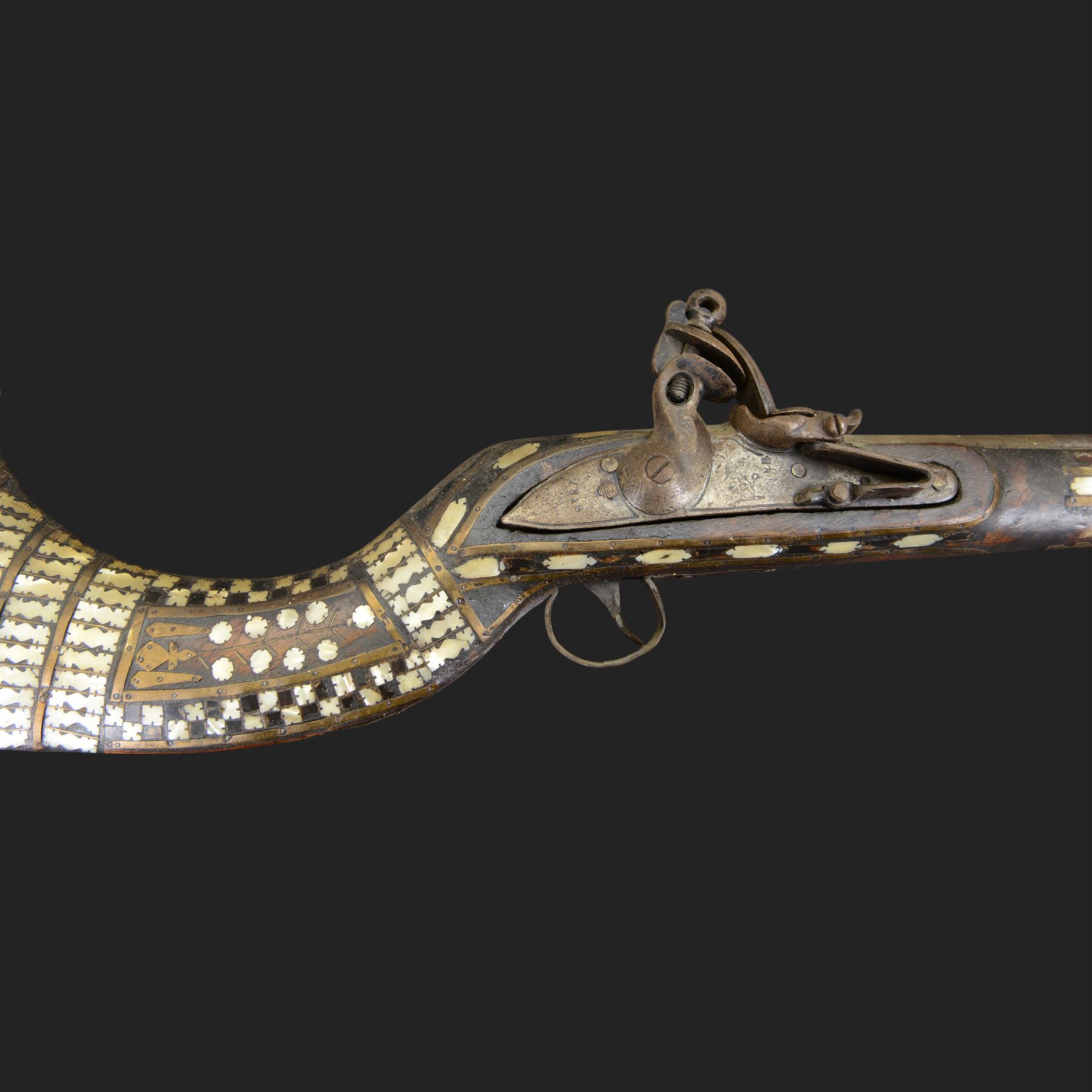 Indian Jezail style flintlock musket, with 118cm barrel, the East India Company lock marked 1818,  the curved butt inlaid with mother of pearl and brass decoration, overall L155cm