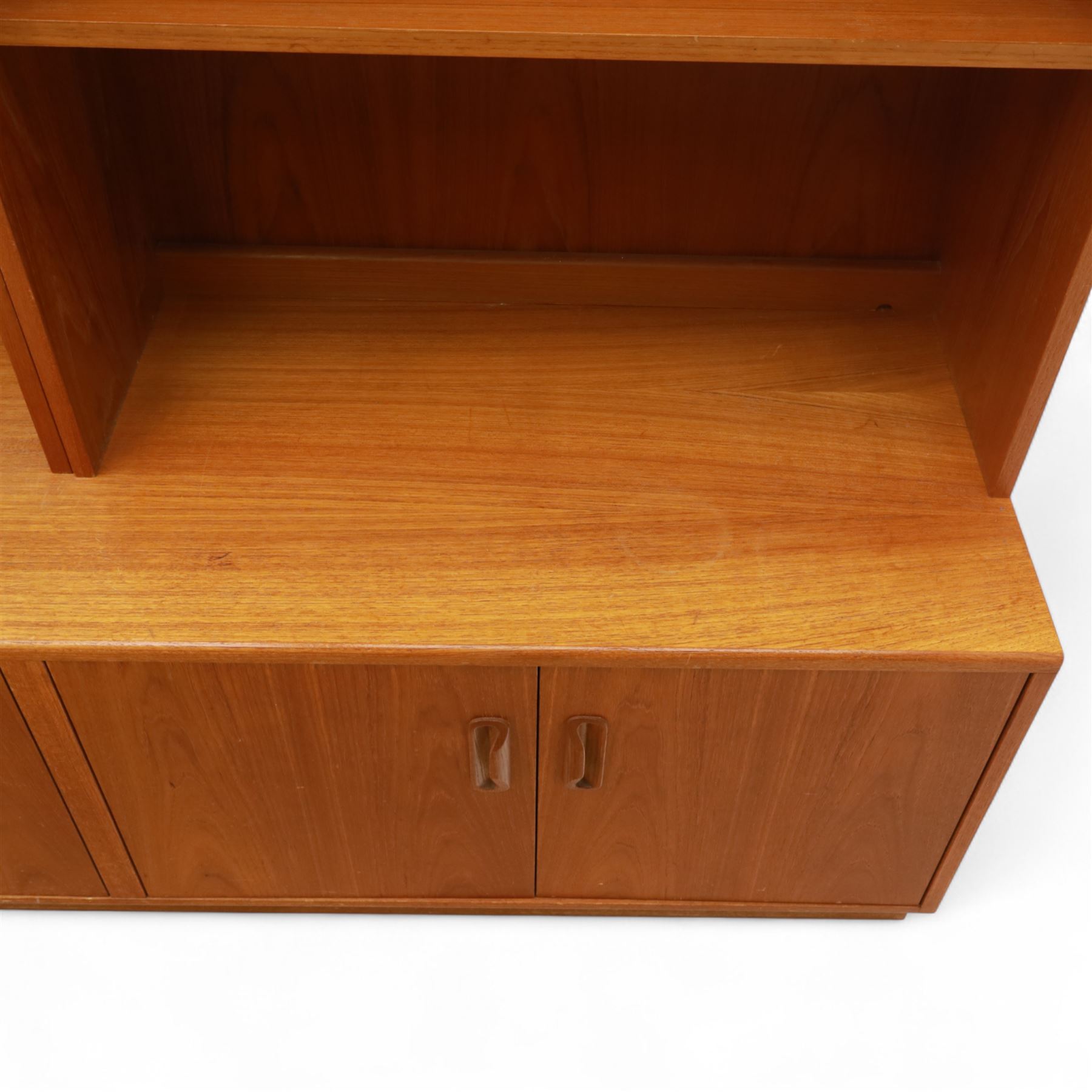 G Plan - Mid 20th century teak sectional wall cabinet, comprising six modular units including a fall front bureau, glazed display cabinet, open bookcase, cupboard and drawer bases, each with recessed handles and flush plinths