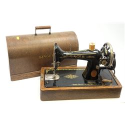 A cased vintage Singer hand crank sewing