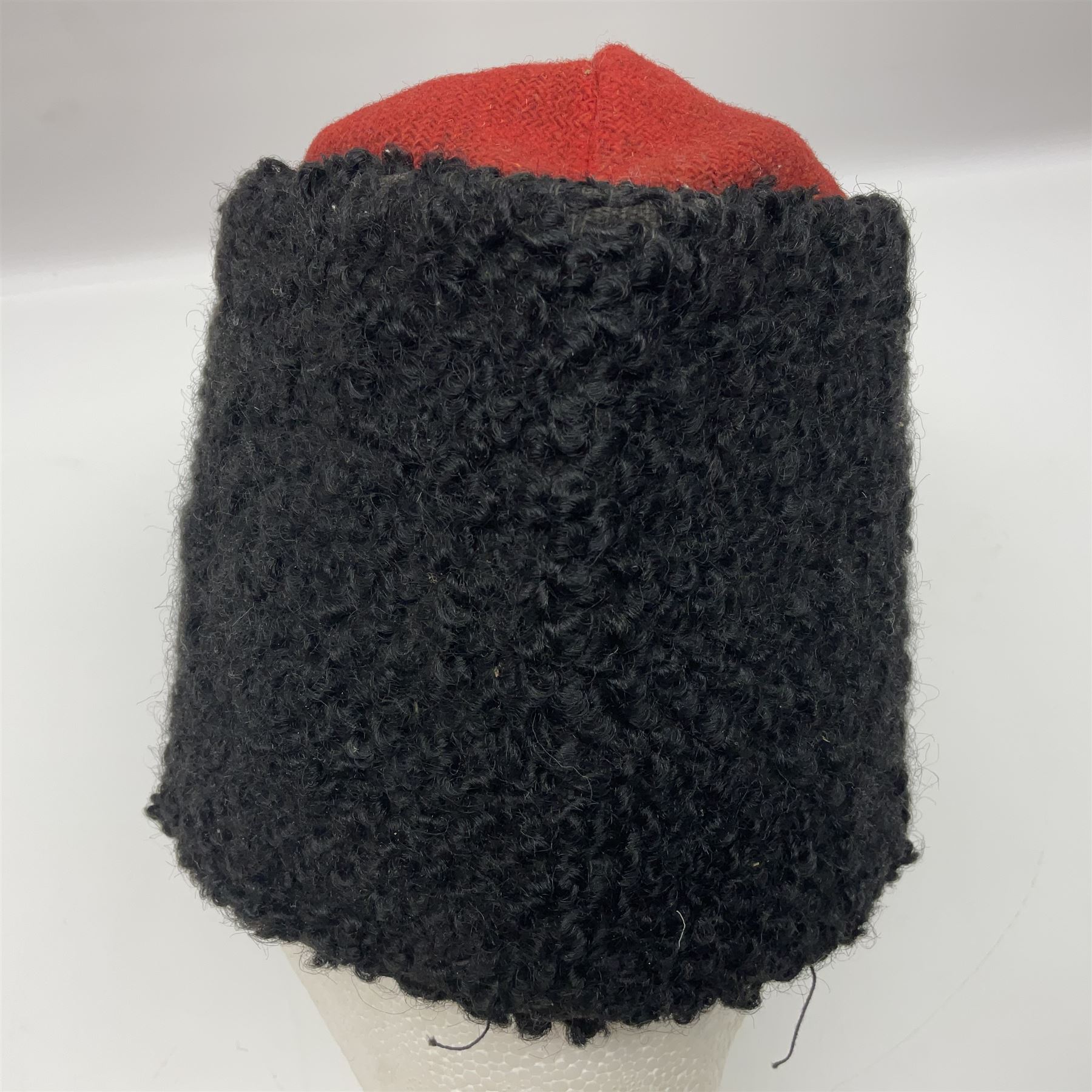 WW2 German small size Balkan style hat with 'SS' metal badges; red cloth top and flash to front with black persianelle type sides; lined in brown card with leather sweatband