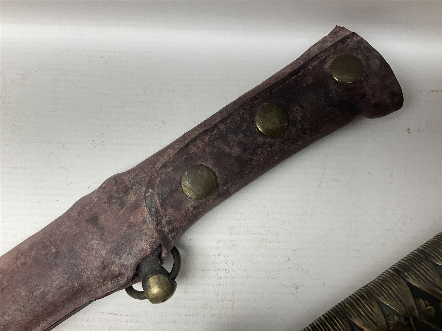 Copy of a WWII Japanese NCO sword, the 65cm slightly curving blade stamped with pseudo Japanese characters and cast brass simulated cord bound grip; in officer's leather bound field scabbard L97cm overall