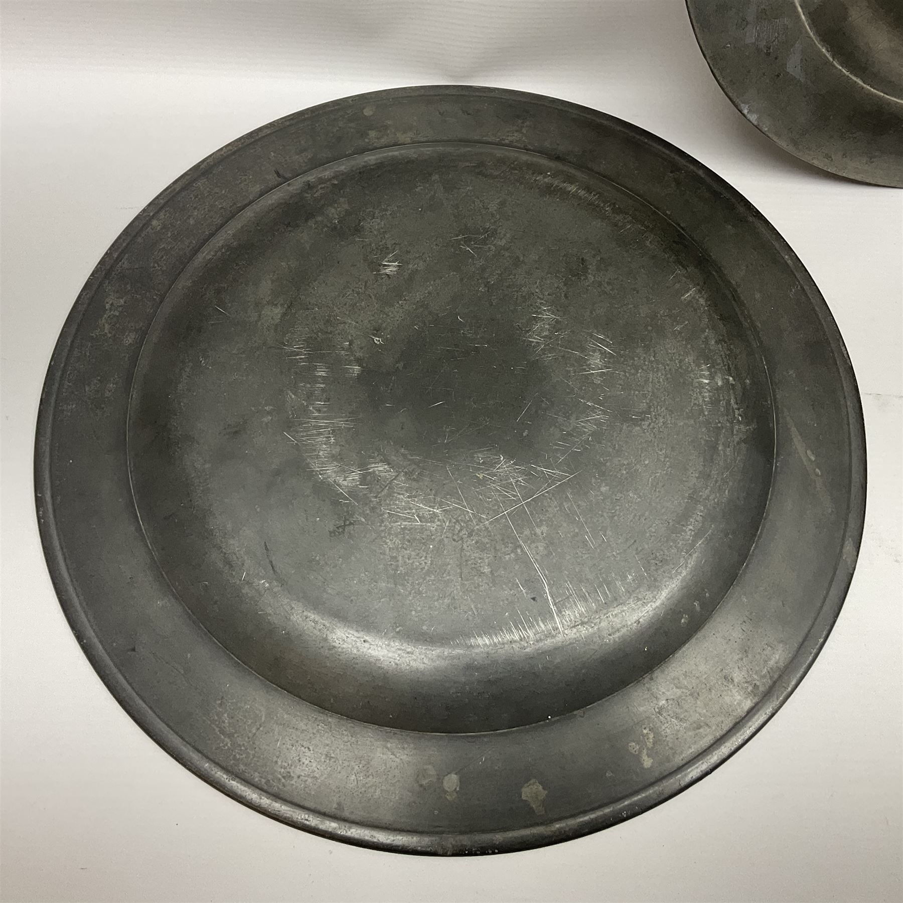Group of seven 19th century pewter chargers, each of circular form with dished centre, two examples with touch marks verso, each approximately D39cm