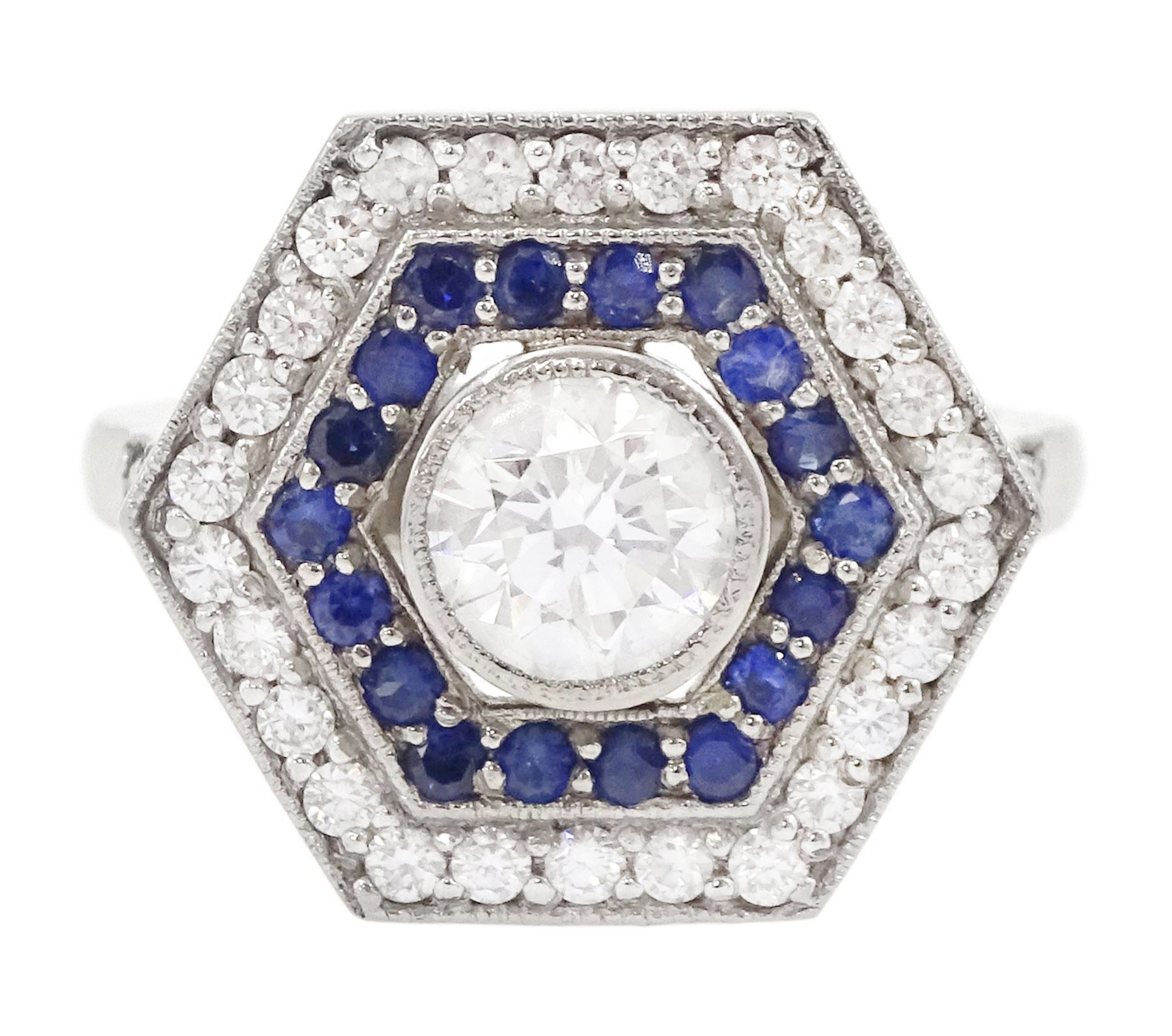 Platinum diamond and sapphire hexagonal ring, the principle diamond of approx 0.55 carat, with sapphire and round brilliant cut diamond surround, all milgrain set, hallmarked