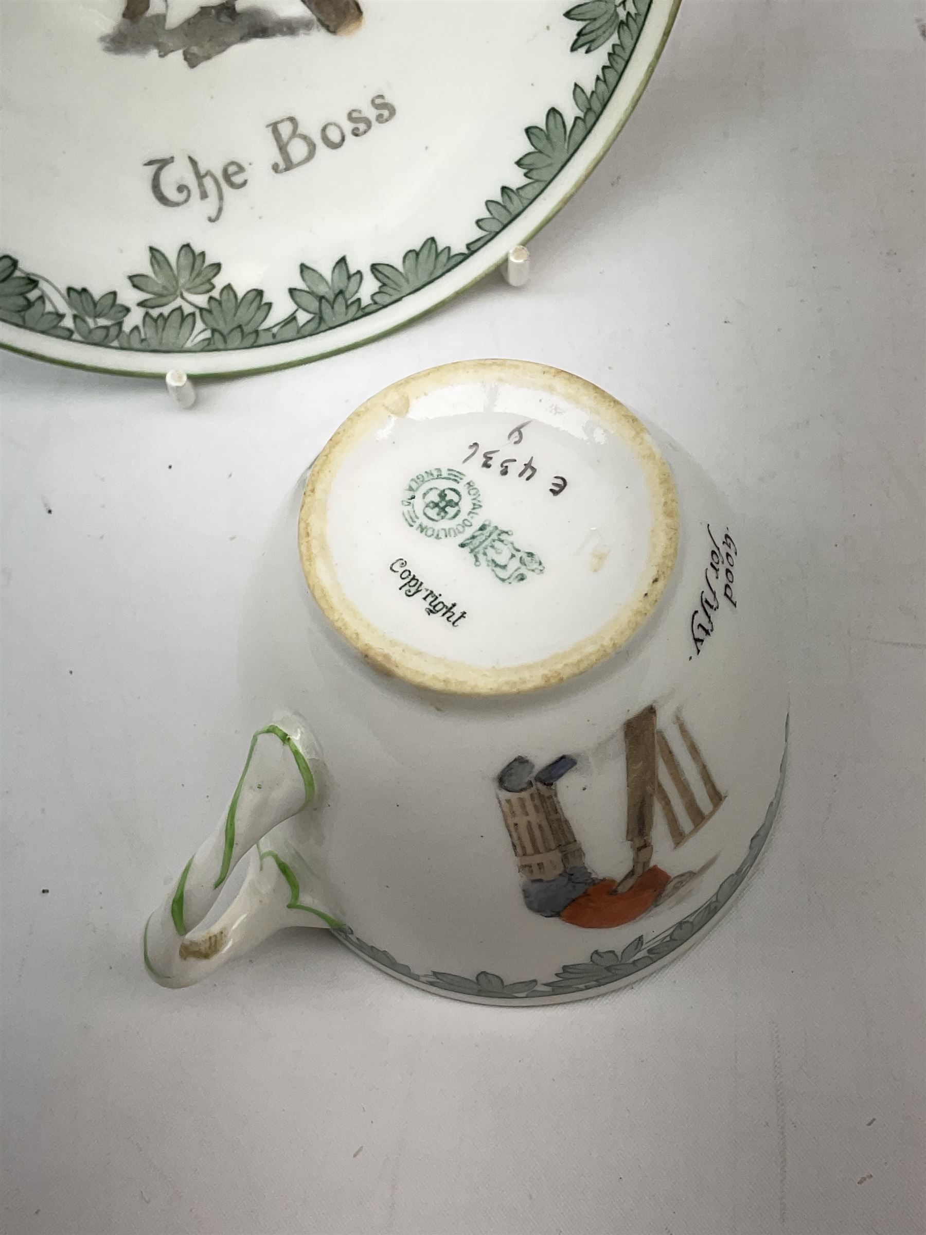 Early 20th century Royal Doulton teacup and saucer, from the series 'The All Black Team', the teacup depicting a cricketer entitled 'Good for fifty', the saucer depicting a cricketer stood in a long coat and wide brimmed hat, entitled 'The Boss', both with printed mark beneath, cup H6.5cm