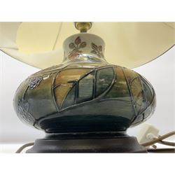 Moorcroft table lamp of squat baluster form, decorated in the Autumn Blackberry, with Moorcroft cream fabric shade with gold, green and red piping, overall H38cm