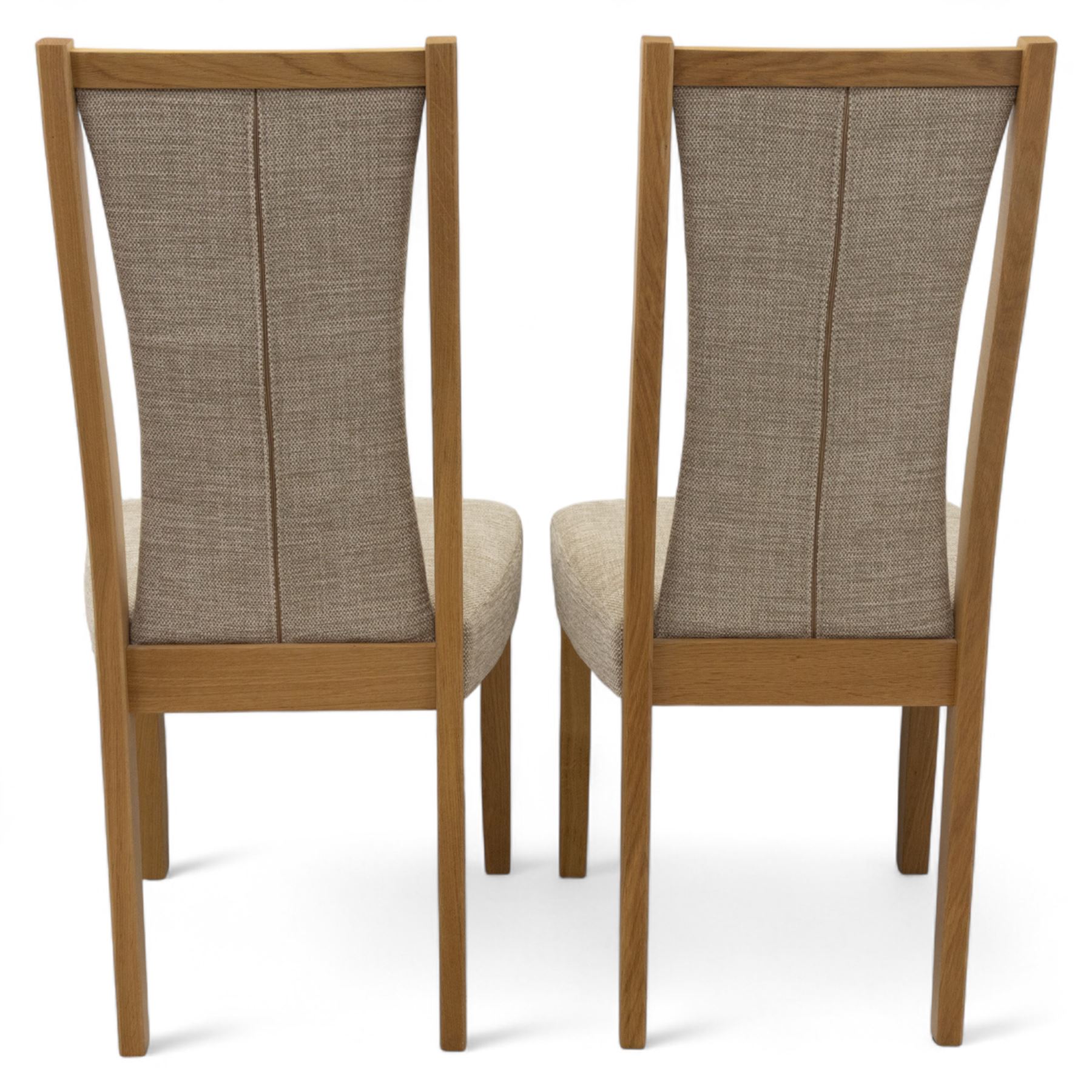 Ercol - light oak ‘Artisan’ rectangular dining table with chamfered top extending fold over top and tapered legs, together with two matching high back dining chairs upholstered in textured beige fabric (Chairs H 98cm, W 47cm, D 52cm)