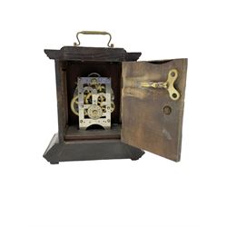 German - late 19th century  Black Forest Junghans alarm clock, profusely carved mouldings with glass side panels and carrying handle, two part dial with a gilt centre, Arabic numerals, minute track and steel spade hands, 30hr  balance wheel movement with alarm sounding on a bell, wound and set from the rear, with Key.