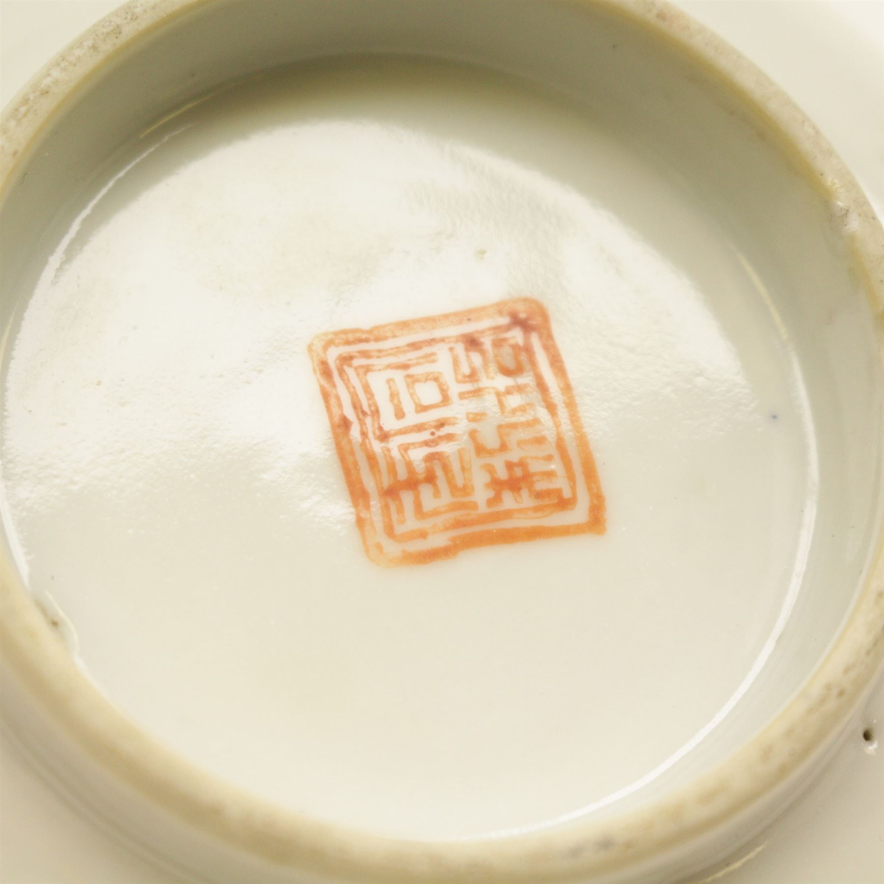 Chinese tea bowl, the enamel decoration depicting floral sprigs within a gilt and blue boarder, with a crowned shield to the centre, together with another bowl and a saucer