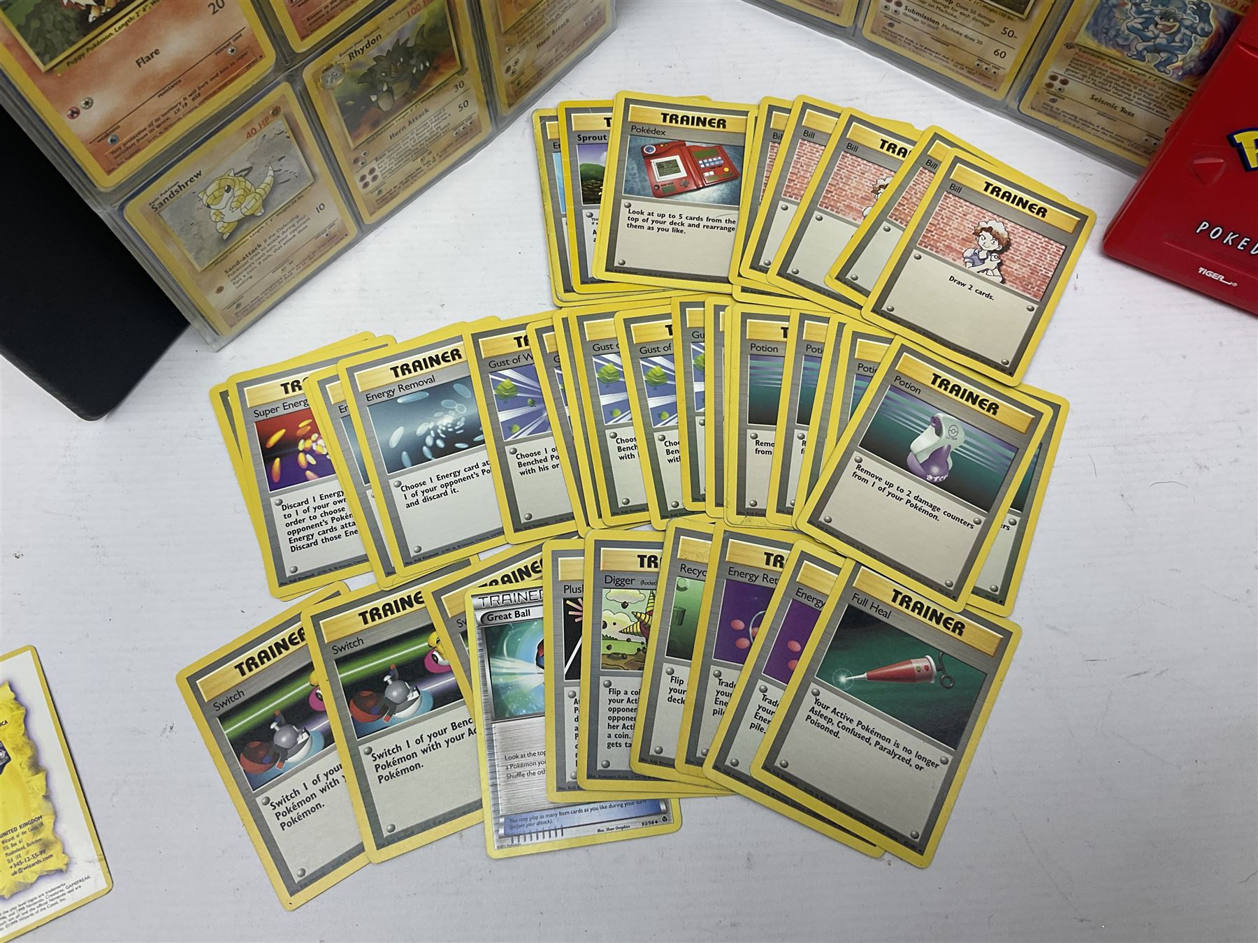 Collection of Pokemon trading cards, mostly 1999 Wizards Pokemon cards to include holo Charizard 4/102, first edition holo Machamp 8/102, further holographic cards; Dark Flareon 35/82 and Dark Vaporeon 45/82, cards from themed sets and 4th edition prints; 1998 Electronic Pokédex with cardboard boxes for themed decks Blackout, Overgrowth and Power Reserve Jungle, along with a large quantity of energy and trainer cards 