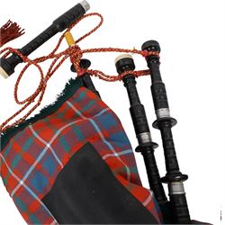Set of ebonised wooden bagpipes, with new bag in Cameron of Lochiel tartan, contained in leather suitcase with initials PAJ to cover