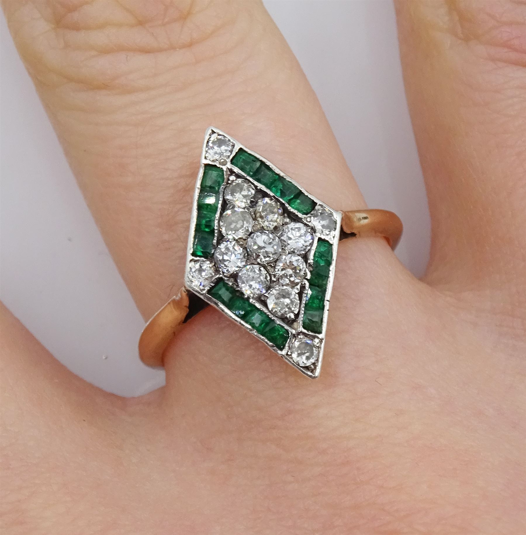 Gold diamond and emerald kite shaped cluster ring, nine old cut diamonds, with calibre cut emerald and diamond set border