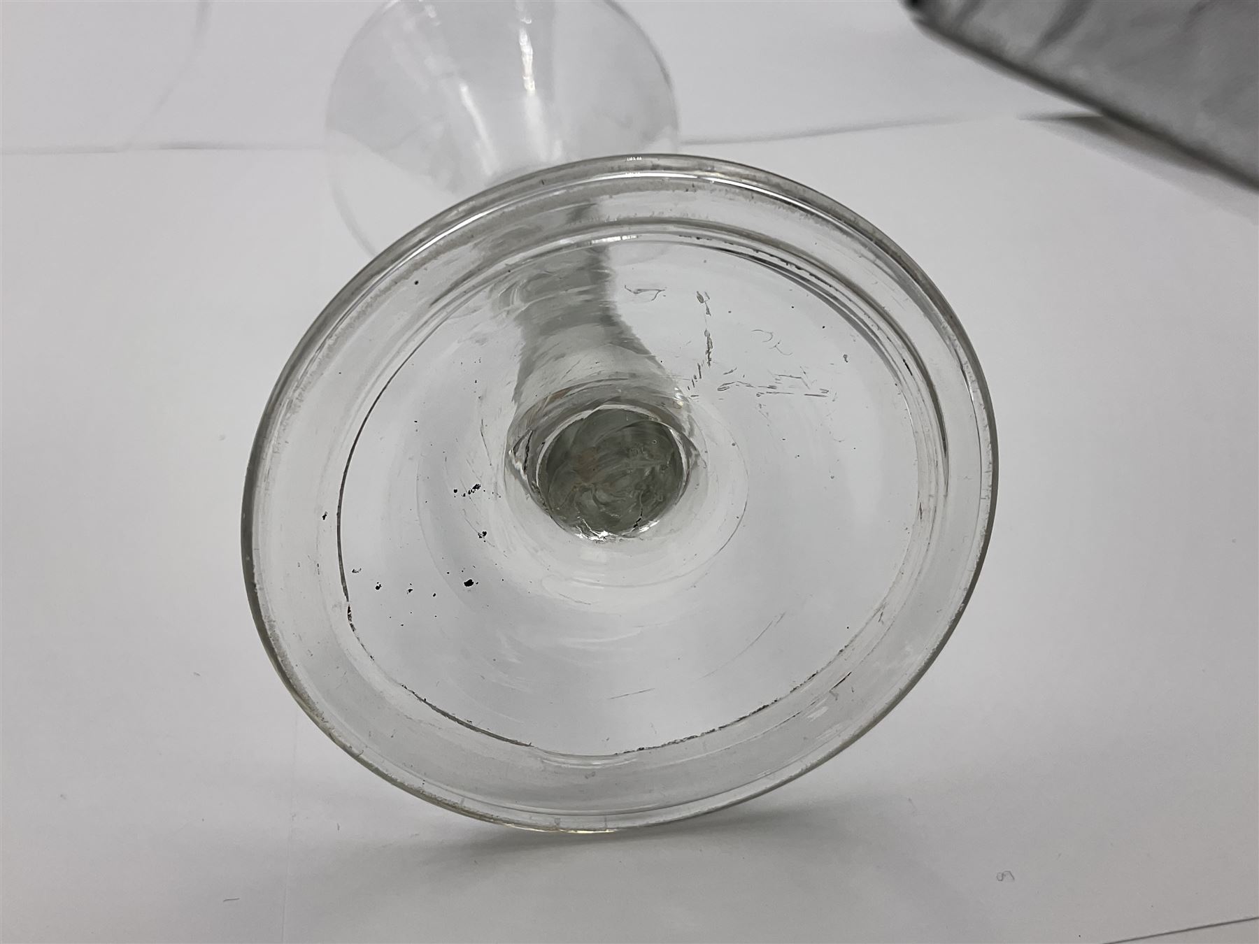 18th century wine glass, the trumpet shaped bowl upon tear drop stem and conical folded foot, H15.5cm, together with an 18th century cordial glass, the round funnel bowl on plain knopped stem and folded conical foot