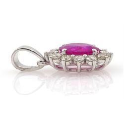18ct white gold ruby and diamond pendant, single oval cut ruby of 1.15 carat surrounded by twelve round brilliant cut diamonds, stamped, total diamond weight approx 0.40 carat