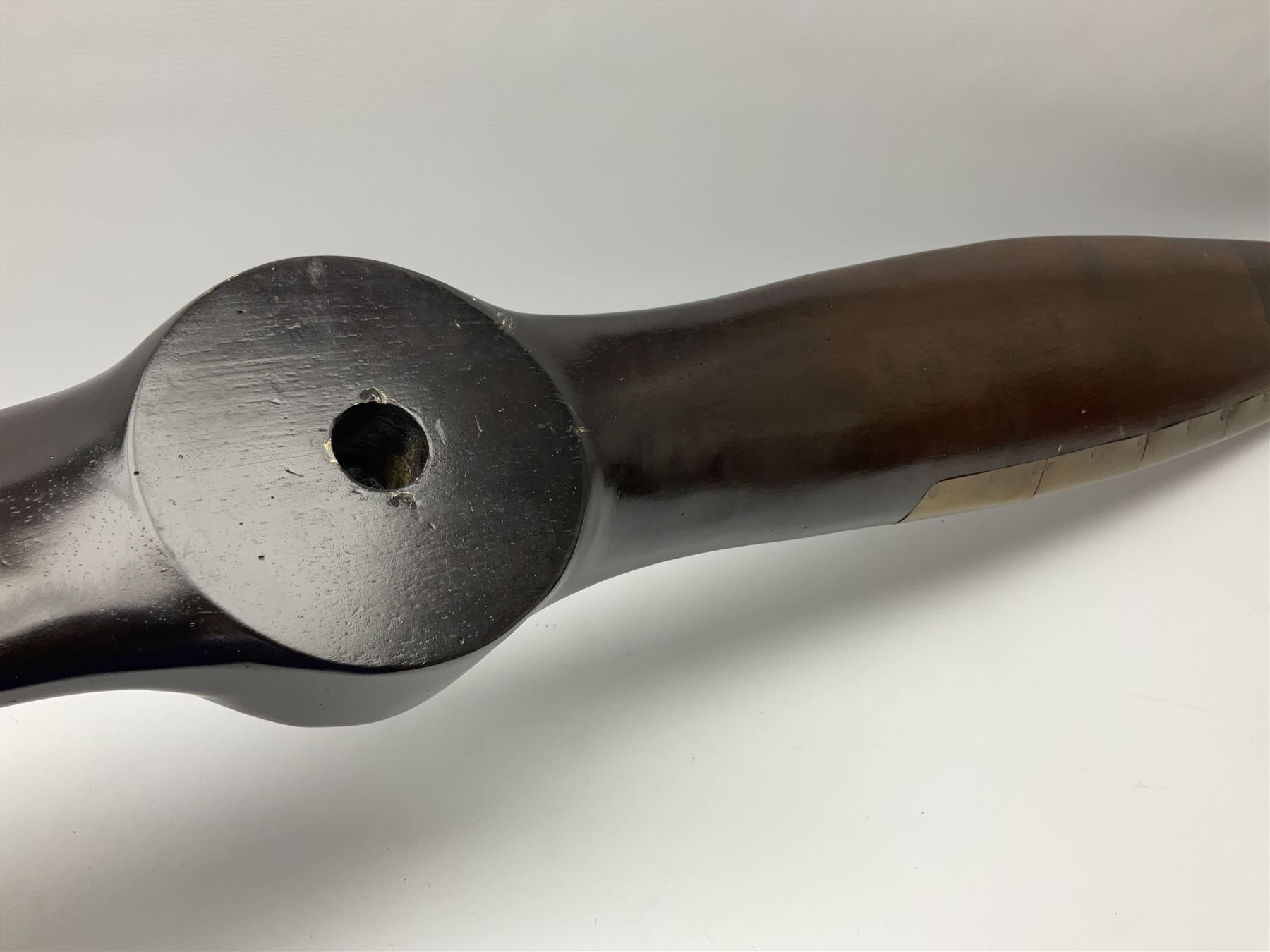 British World War II era laminated wooden four-bladed generator propeller, late 1930s-40s, used to power a drogue winch used by a target tug aircraft; marked with DRG drawing number T29505-2-4 N760 on the hub and impressed circle mark 'P.M.P.W. 1'; light weight four plank mahogany laminate with 9.5cm diameter metal plates mounted to front and rear faces of hub for 15mm shaft; one plate marked T29504-2/198 D91cm; together with a modern reproduction brass edged mahogany two-blade propellor L