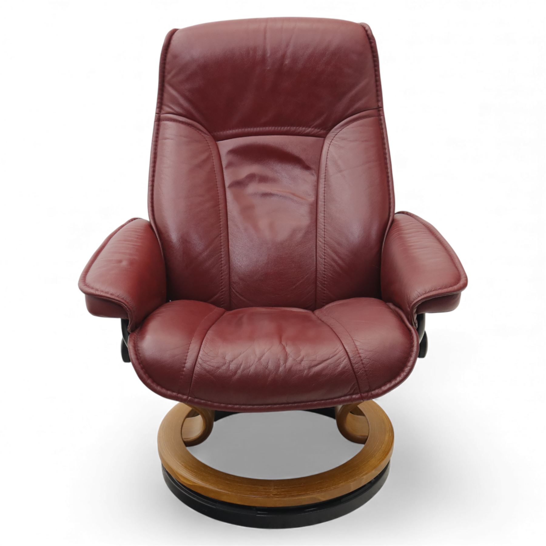 Ekornes - 'Stressless' maroon leather reclining swivel armchair, with high padded back and panel-stitched upholstery, shaped armrests, on a circular laminated wood swivel base