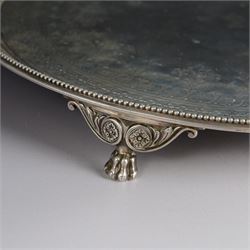 Victorian silver tray, of circular form with beaded rim, engraved to the centre with floral decoration, upon three scroll mounted paw feet, hallmarked Walter & John Barnard, London 1877, D30.5cm