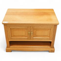 Unicornman - Yorkshire oak media cabinet, rectangular top over a pair of panelled cupboard doors with brass handles, open undertier, on shaped bracket supports above castors