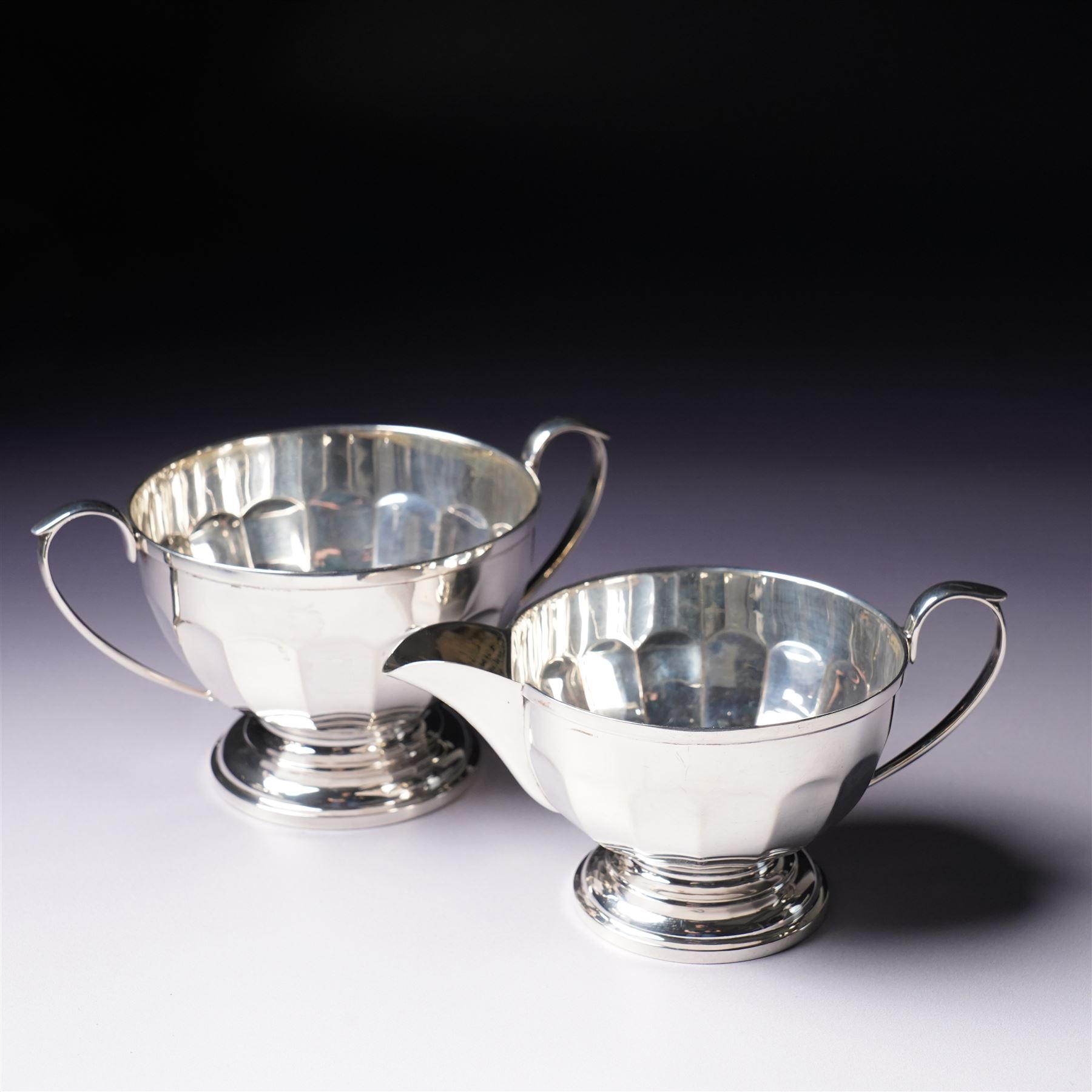 Silver three piece tea set of panelled circular form Birmingham 1929 Maker Synyer & Beddoes and a similar hot water jug Sheffield 1954 