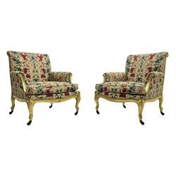 William Bertram & Son of London - pair late 19th century giltwood armchairs, moulded frame with scroll carved back and arm terminals, upholstered in striped fabric with foliate pattern, on shell carved cabriole supports, the brass castors stamped 