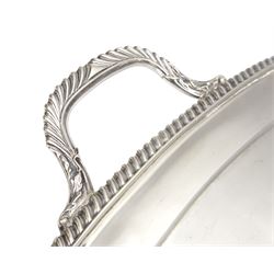 Raich Carter - presentation hallmarked silver two-handled tray of rounded oblong form with gadrooned rim by Wilson & Gill, 139 Regent Street, London, inscribed to the centre 'Presented to Mr. & Mrs. Raich Carter by the Lord Mayor of the City and County of Kingston-upon-Hull Alderman R.E. Smith J.P. on May 30th 1952on behalf of the many Admirers who subscribed to The Lord Mayor's Testimonial Fund in recognition of Raich Carter's genius as a footballer and his services to the City', London 1937 82oz L61cm; together with a hallmarked silver four-piece tea and coffee set by Cooper Bros. & Sons Ltd, the teapot of London shape with ebonised handle and knop, each piece engraved with an initial 'C', Sheffield 1920  60.5oz, teapot L29.5cm