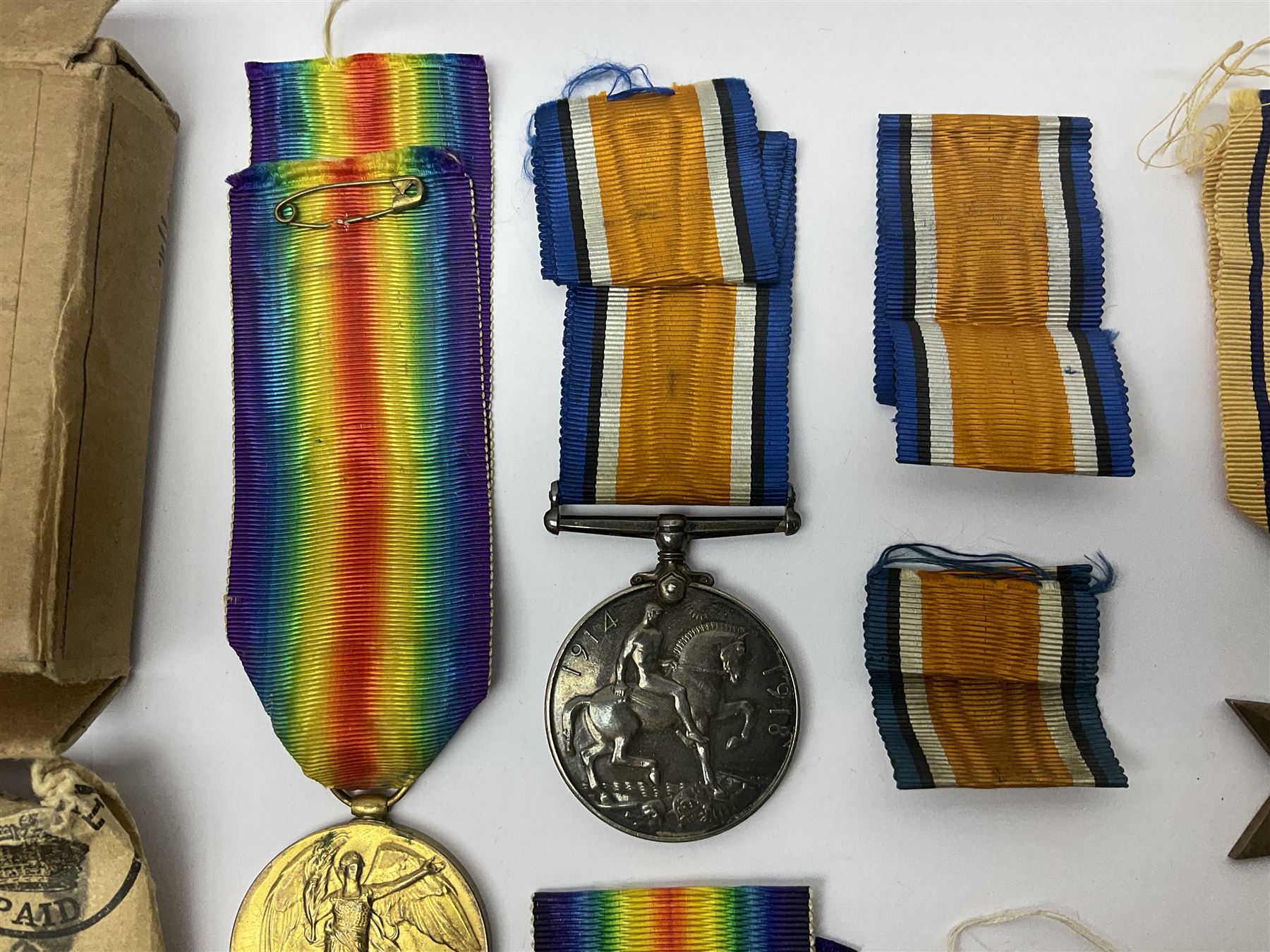 WWI pair of medals comprising British War Medal and Victory Medal awarded to 32682 Pte. W. Meadows W. Rid. R. in issue box; WWI pair of medals comprising 1914-15 Star and Victory Medal awarded to 3720 Pte. (later Cpl.) E. Petty W. York. R. with issue letter from Tank Corps; WWII group of five medals comprising 1939-45 War Medal, Defence Medal and 1939-45, Italy and Africa Stars; all with ribbons; and book of nineteen seaman's Certificates of Discharge to cook Charles Filburn 1893 - 1901 from various British ports