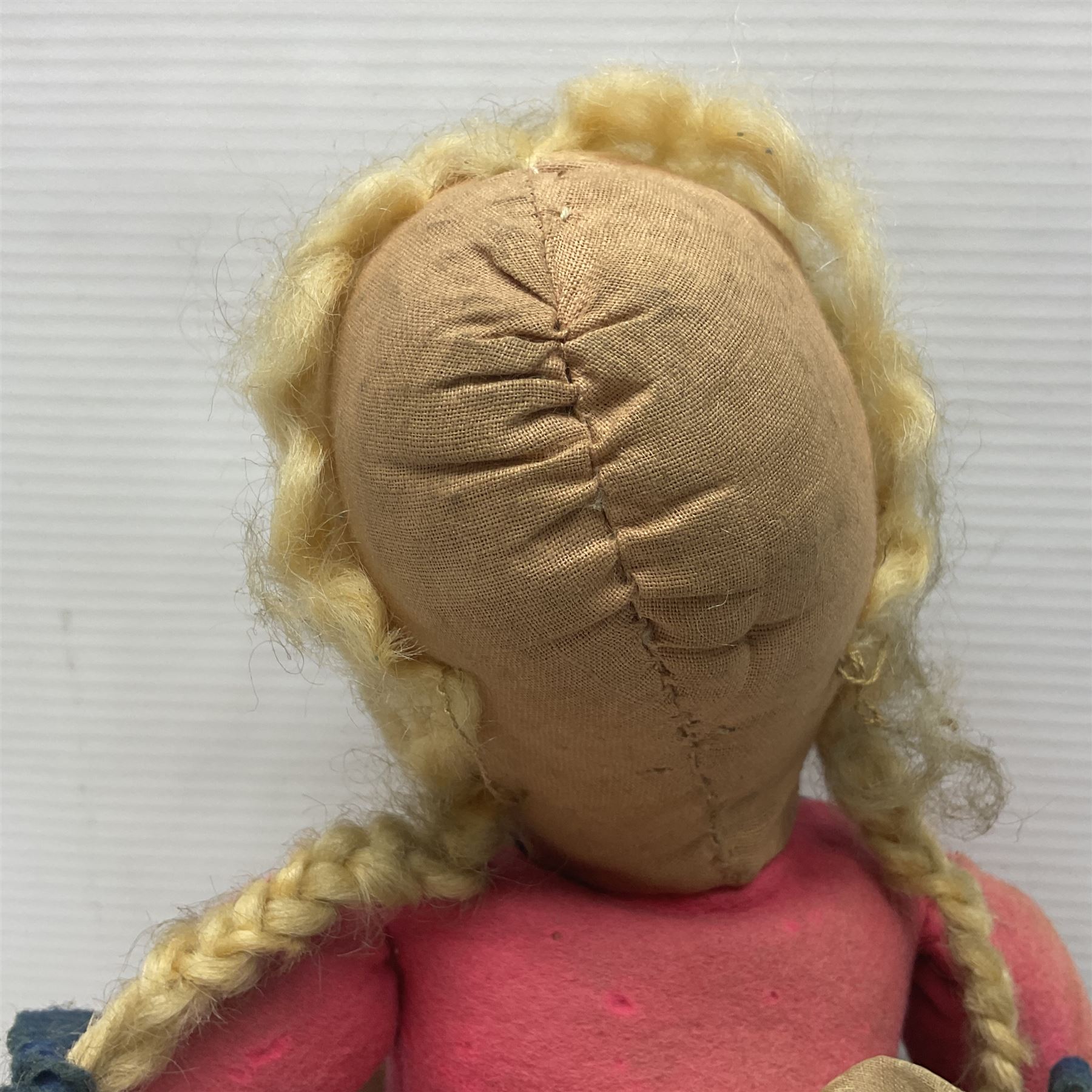 Farnell Alpha Toy soft toy of a Dutch girl, the pressed felt head with applied hair and painted features and overstuffed full length dress with apron and clogs; inoperative clockwork musical movement H31cm