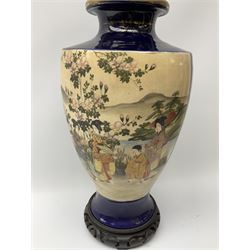 An early 20th Century Japanese vase, of baluster form decorated with panels of figures in a garden setting, upon deep blue ground, with character mark beneath, H37cm. 