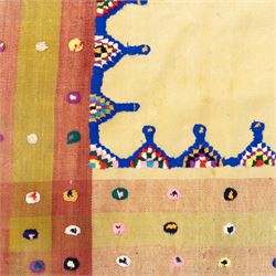 Persian Jajim flatweave kilim, plain beige central field, framed by stepped indigo and polychrome inner border within broad striped outer bands in rose, green, and ivory, decorated with knotted wool tufts and fringe ends 