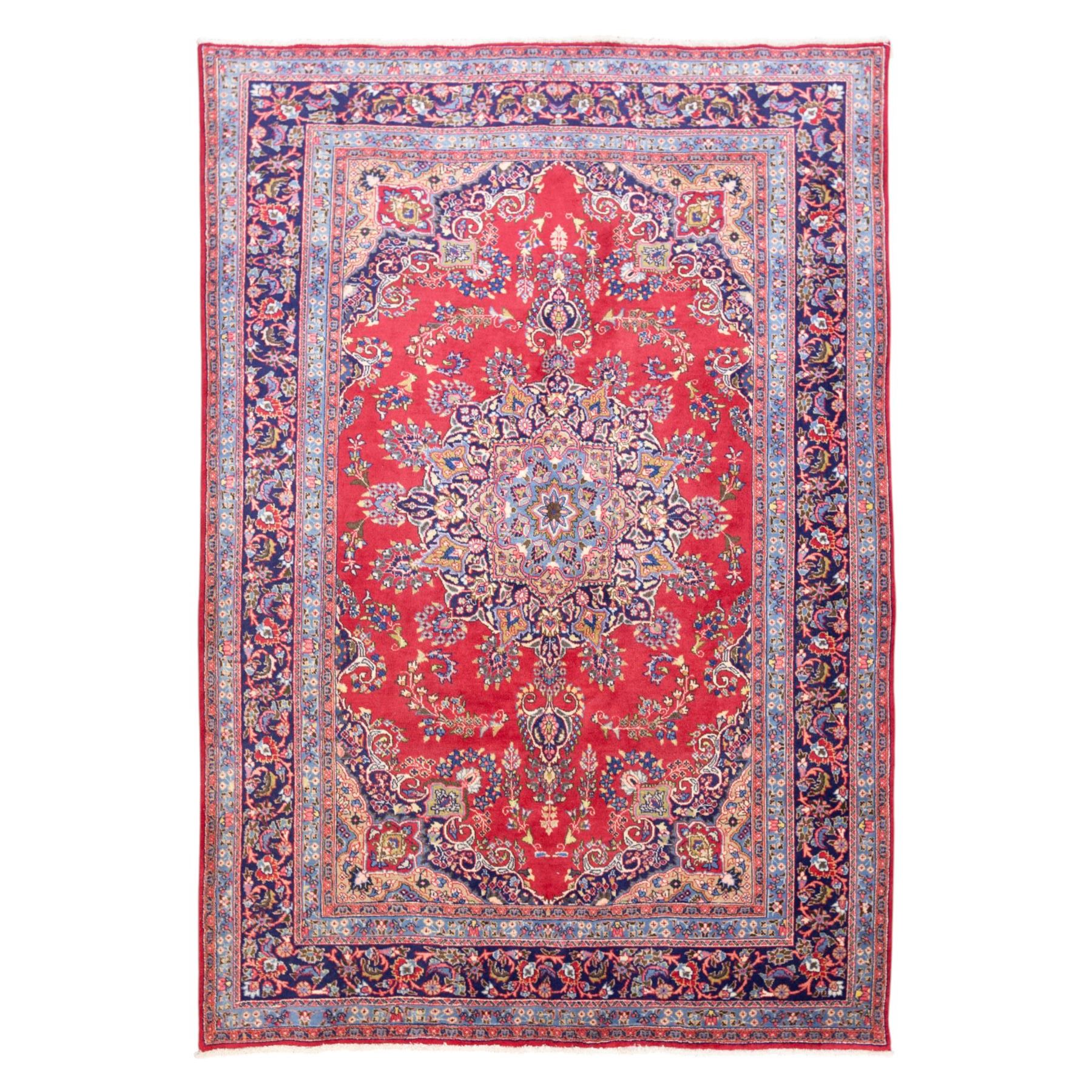 North East Persian Meshed hand-knotted rug, madder red field with central multi-lobbed medallion in shades of indigo, ivory, and sofa pastel tones surrounded by scrolling floral vines, palmettes, stylized blossoms, floral sprays, and cartouches, framed by Indigo spandrels, enclosed within a broad dark blue main border, flanked by multiple narrow guard stripes, with fringe ends 