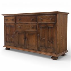 Ercol - elm dresser sideboard, fitted with four drawers and four cupboards with carved detail, drawer featuring cutlery slide