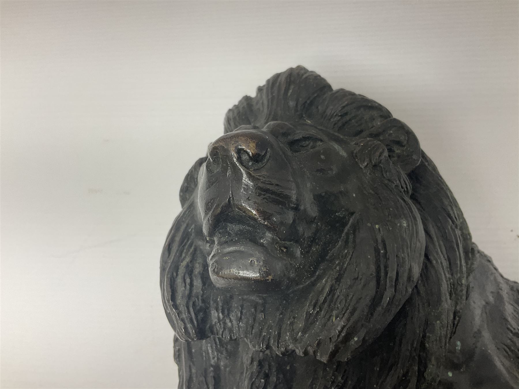 After Paul Edouard Delabrierre (French, 1829-1912), bronze, model of a lion, upon an oval base, signed E Delabrierre, overall H29.5cm, L46cm