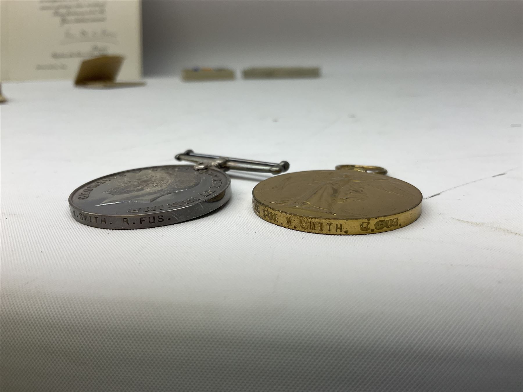 WW1 group of three medals comprising British War Medal and Victory Medal in issue box and Ceylon Volunteer Service Medal awarded to 10288 Pte. M. Smith R. Fus.; together with a later awarded WW2 Defence Medal in modern box with slip; and his QEII Imperial Service Medal in case and box with certificate dated 1959