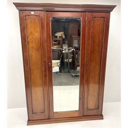 Victorian mahogany triple wardrobe, central mirrored door enclosing linen slides and two short and two long drawers flanked by two cupboards, plinth base