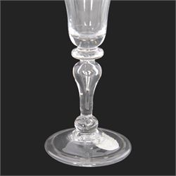 Mid 18th century wine glass, circa 1730-1740, with bell shaped bowl upon an inverted baluster stem with internal tear and basal knop, upon conical folded foot, H15cm
