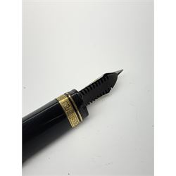 An Omas 360 fountain pen, the black triangular section body with gold coloured clip and banding, and Greek Key border to the cap, the bicolour nib marked 750 18K.