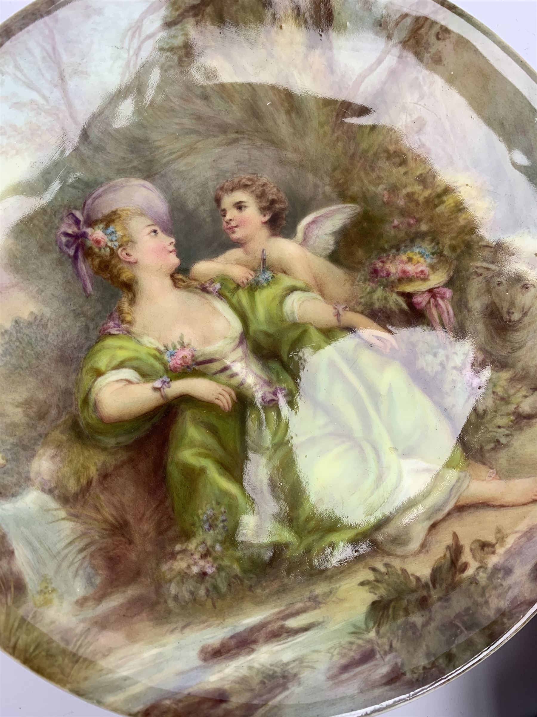 Late 19th century porcelain plate, hand painted by Frederick Sutton, depicting a female figure and putto within a wooded landscape, with recumbent sheep and brook to the fore, signed F N Sutton, unmarked verso, D22.5cm

Frederick Sutton was employed as a painter at the notable factories of Royal Worcester, Coalport, and Minton. 
