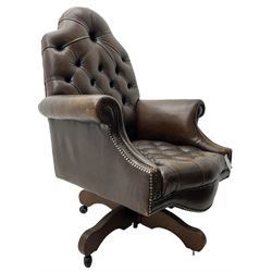 Georgian design office swivel armchair, high arched back over rolled arms and shaped apron, upholstered in deep buttoned dark tan leather with studwork, over swivel and reclining action base