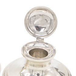 Two early 20th century silver mounted capstan inkwells, both of typical form, the first example hallmarked Wilmot Manufacturing Co, Birmingham 1918, the second example hallmarked Spooner Clowes & Co, Birmingham 1908, largest D15cm, H9.5cm