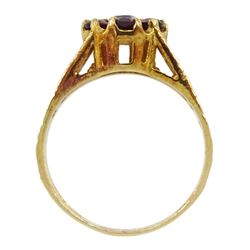 9ct gold garnet flower head cluster ring, with textured and pierced shoulders by Slade & Kempton, London 1978