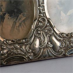 Late Victorian silver double photograph frame, embossed with flowers, scrolls and leaves, hallmarked Cooper Brothers, Sheffield 1899, H13cm, W17cm