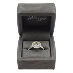 Platinum round brilliant cut diamond halo ring, with diamond set shoulders, stamped PT 950, central diamond 2.09 carat, colour M, clarity SI1, total diamond weight 2.61 carat, retailed by Berry's, with copy of GIA certificate and Berry's document