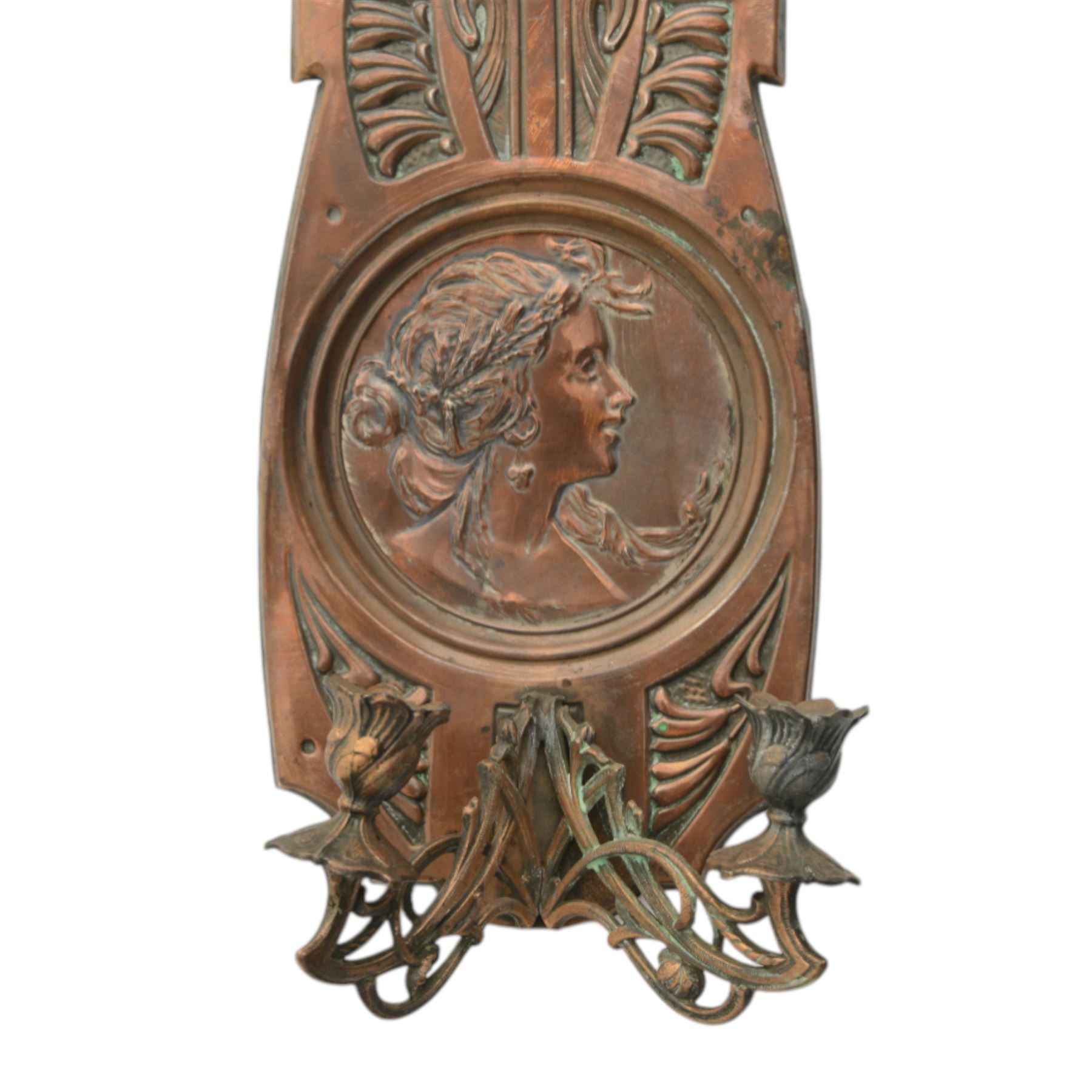 Pair of late 19th/early 20th century Art Nouveau copper twin branch wall sconces, each with shaped back plate chased with a central panel of a maiden in profile above and surmounted by foliate motifs, supporting two foliate open cast branches with bud sockets above conforming drip pans, H31cm W16cm D8.5cm
