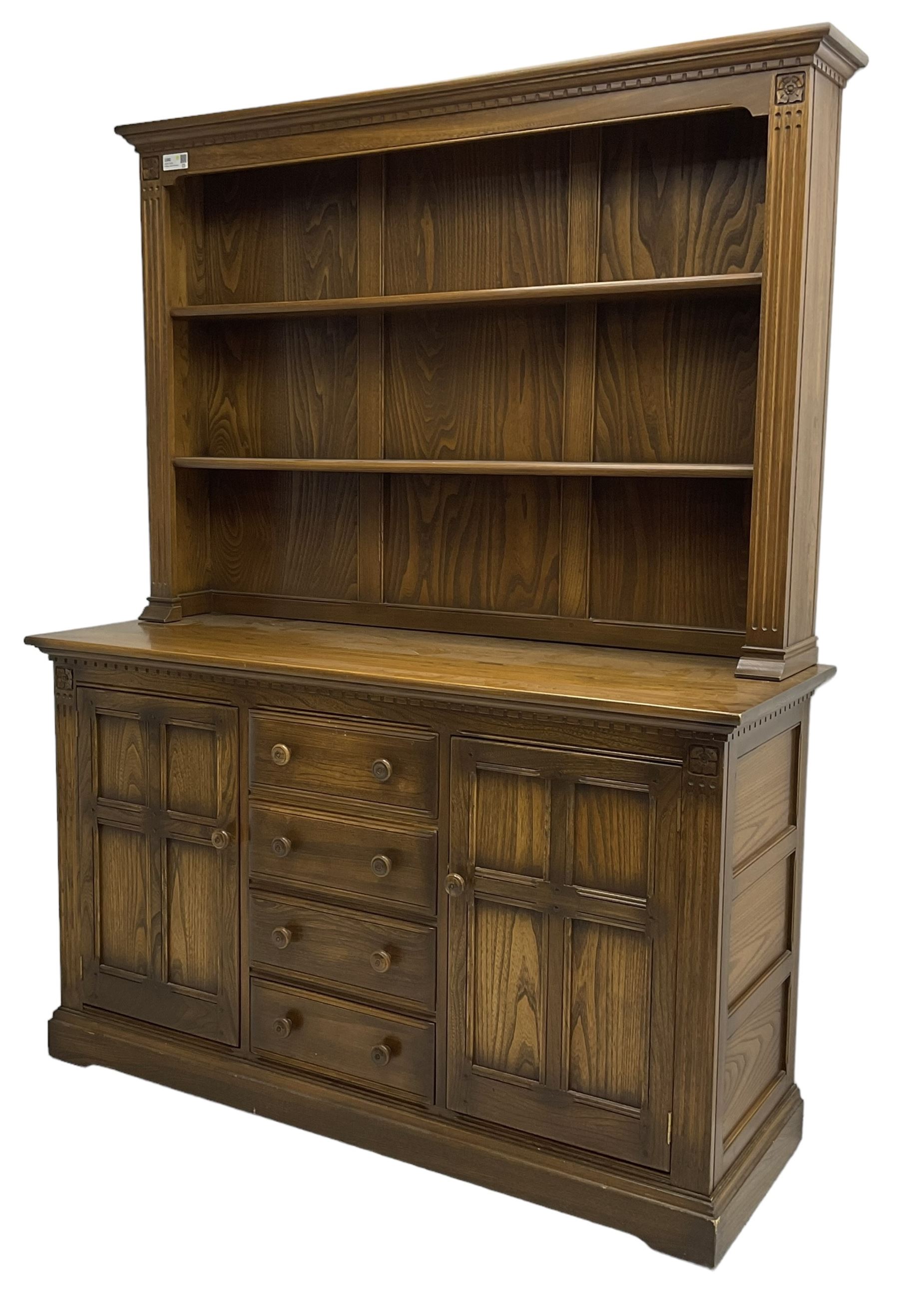 Ercol - mid-20th century dark elm 'Old Colonial' dresser, two tier plate rack with fluted uprights, base fitted with four drawers flanked by two panelled cupboards