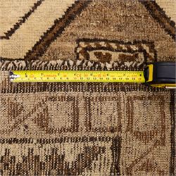 North West Persian Gabeh hand-knotted rug, natural ivory field with a vertical sequence of three large stepped geometric medallions in soft shades of brown and taupe, each enclosing stylized tribal motifs, flanked by narrow guard borders incorporating chevron and zigzag designs, with fringe ends 