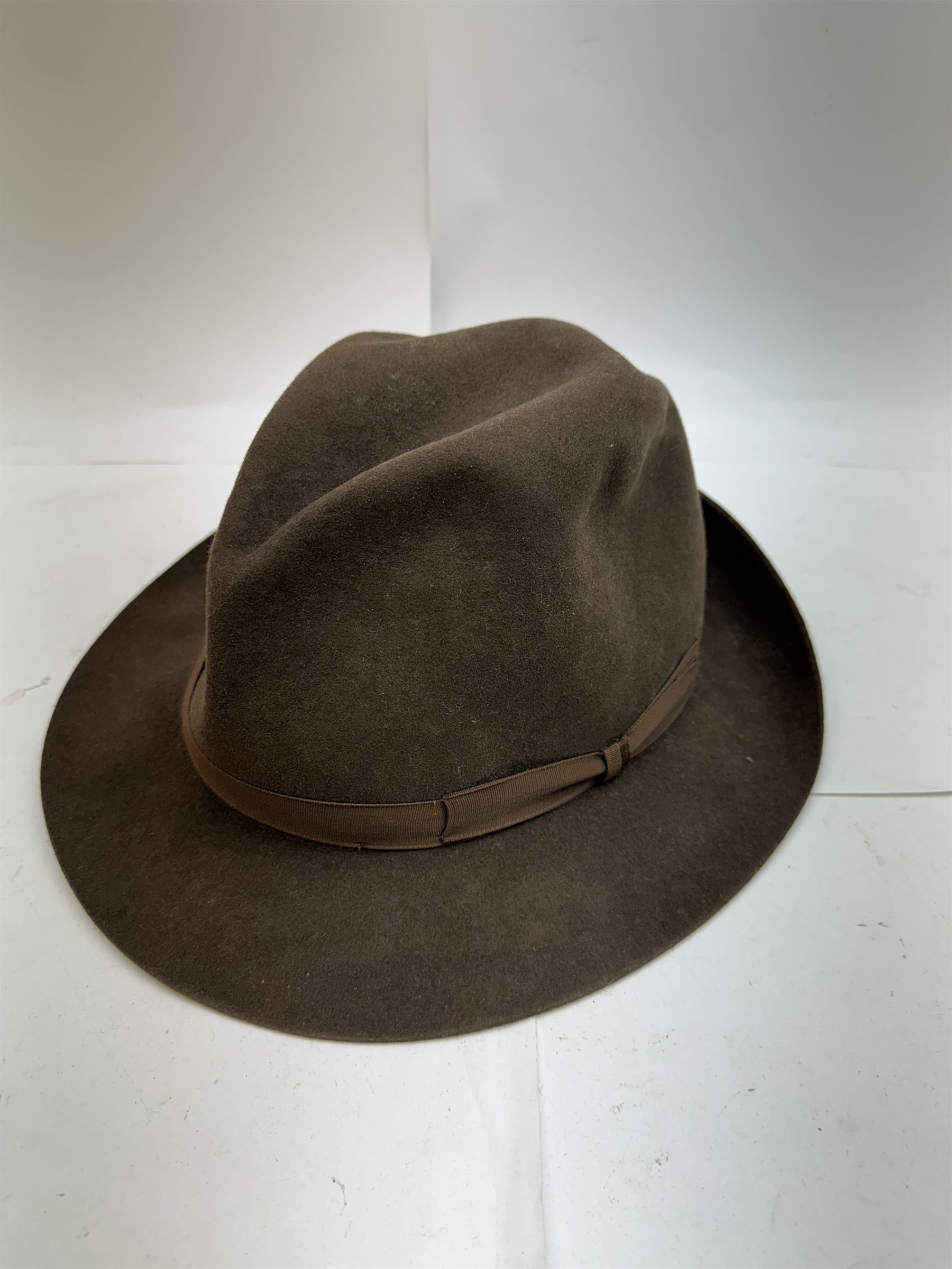 Akubra pure fur felt trilby hat, together with another trilby and two top hats, one by Woodrow and one by Dunn & Co