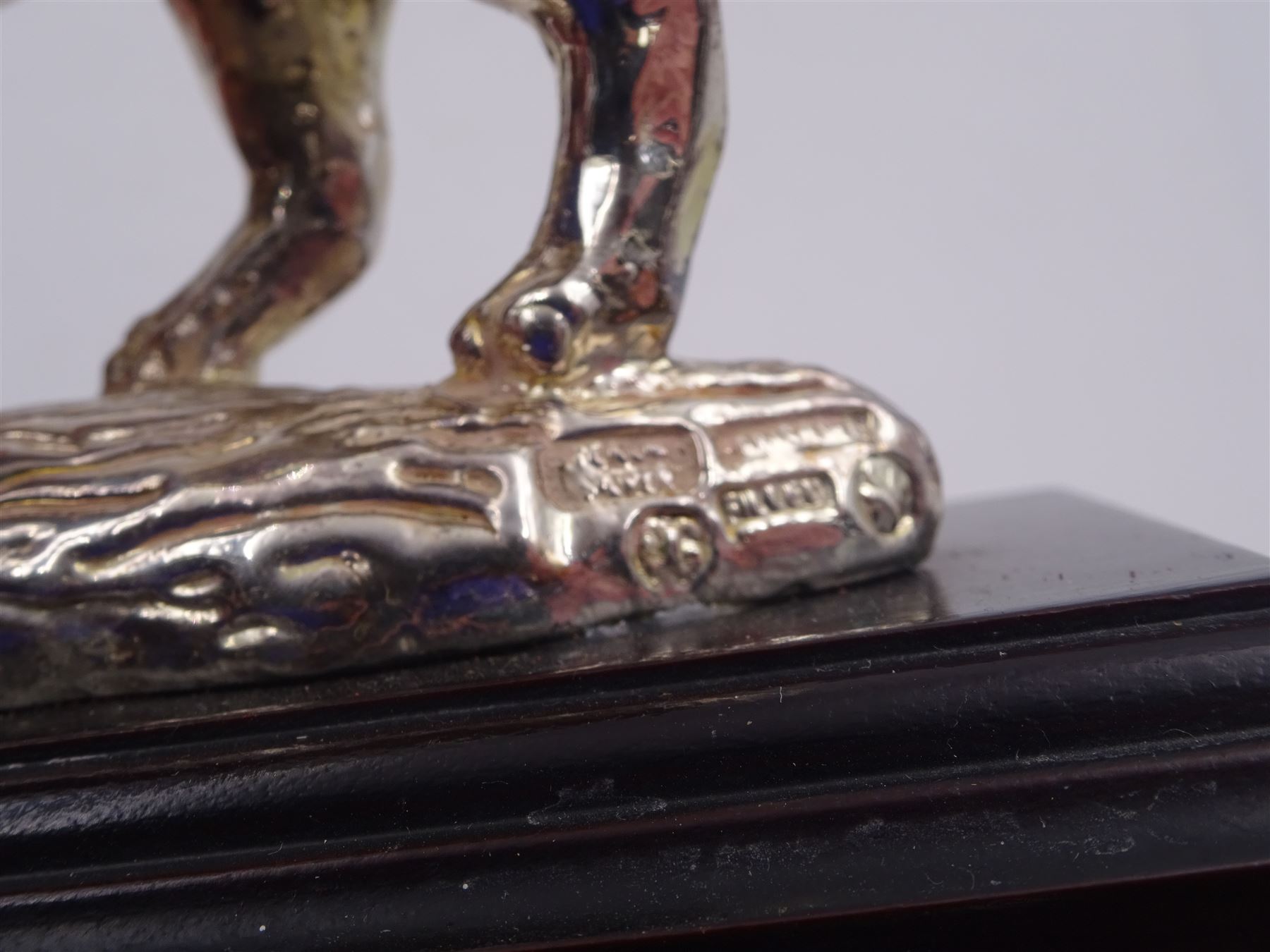 Filled silver model of a rhinoceros by Afrisilver, upon lacquered wooden base, H11.5cm